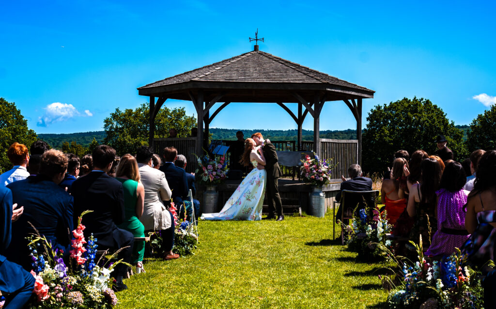 First kiss on wedding day outdoor ceremony